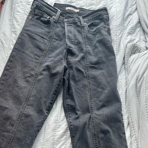 Black wash Levi’s high rise ankle jeans with front detailing